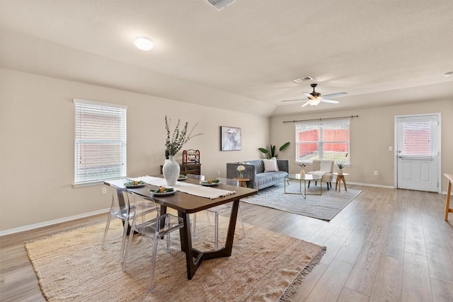 interior space featuring a ceiling fan, visible vents, light wood-style floors, and baseboards