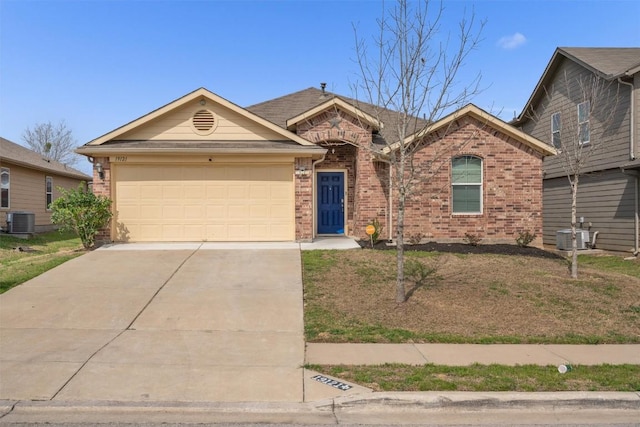 single story home with central air condition unit, brick siding, a garage, and concrete driveway