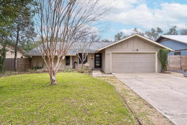 ranch-style house with fence, an attached garage, a front lawn, concrete driveway, and board and batten siding