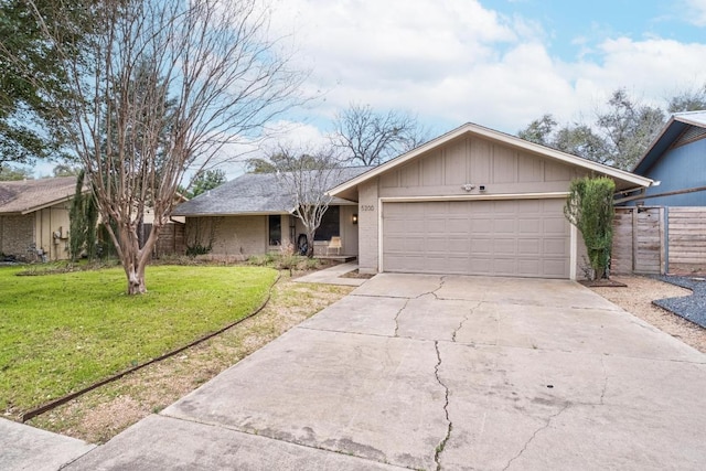 single story home with brick siding, fence, a front yard, a garage, and driveway