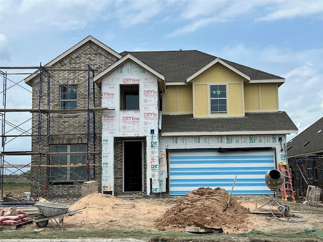 property in mid-construction with a garage, a shingled roof, and brick siding