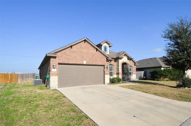 view of front of home with a front yard, fence, a garage, central air condition unit, and brick siding