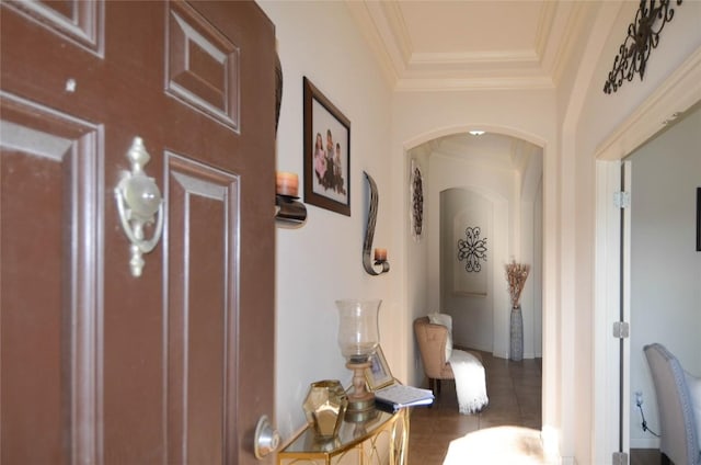 corridor with arched walkways and crown molding