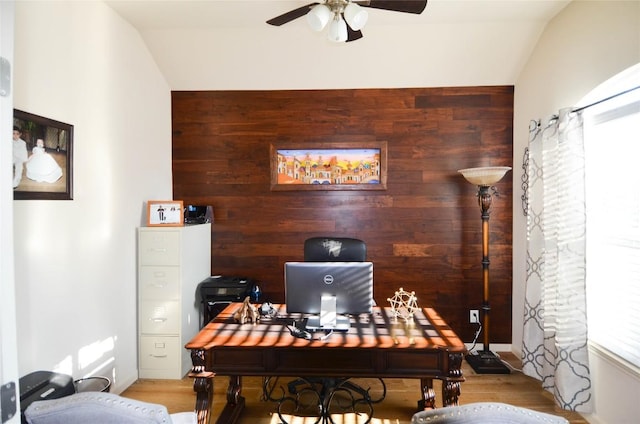 office with wood walls, ceiling fan, and wood finished floors