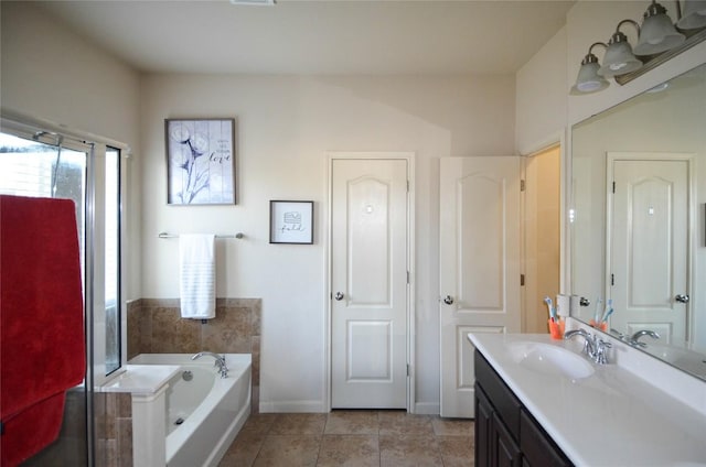 bathroom with vanity, visible vents, baseboards, tile patterned flooring, and a bath