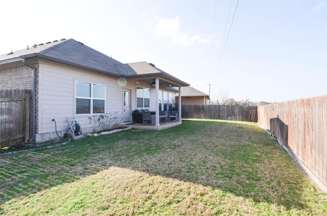 back of property featuring a lawn, a patio, and a fenced backyard