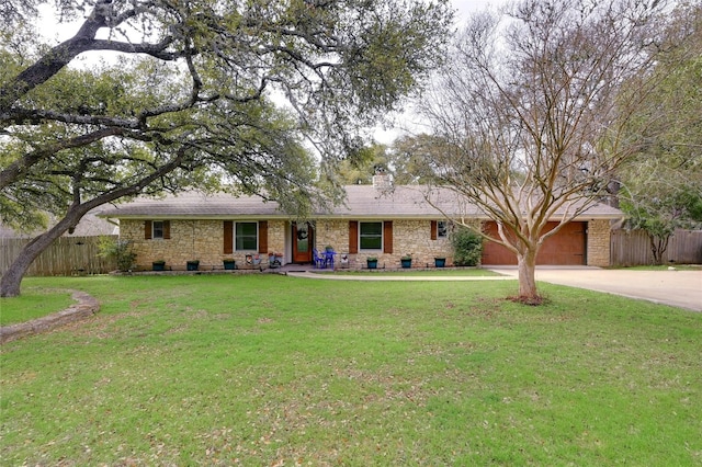 ranch-style home with concrete driveway, a front yard, and fence