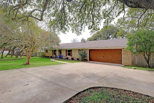 ranch-style house featuring a front lawn, concrete driveway, a garage, and a chimney