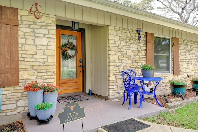 view of exterior entry featuring stone siding