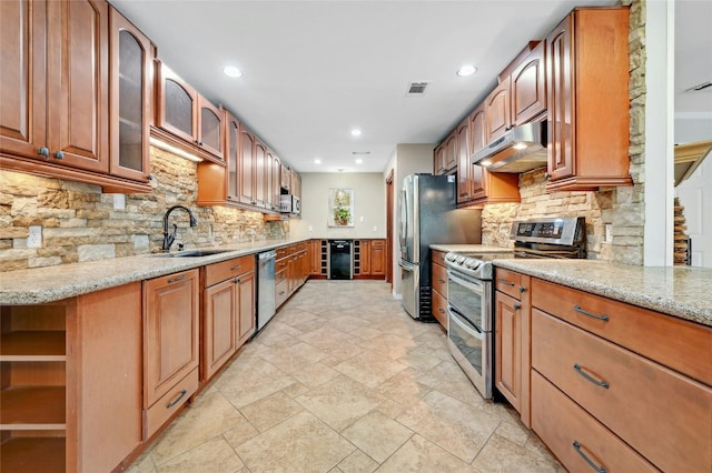 kitchen featuring under cabinet range hood, light stone counters, a sink, stainless steel appliances, and wine cooler