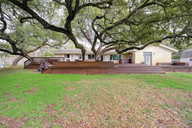 view of yard featuring a wooden deck and fence