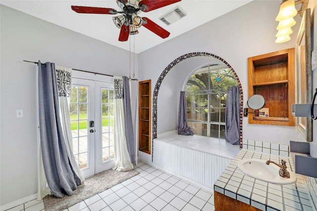 foyer entrance featuring tile patterned floors, visible vents, a ceiling fan, and french doors