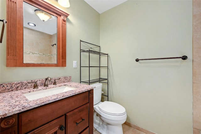 full bath featuring vanity, toilet, and tile patterned flooring