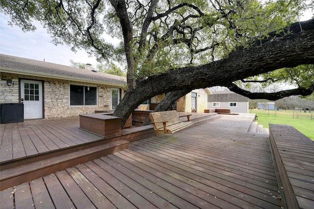 wooden terrace with a yard