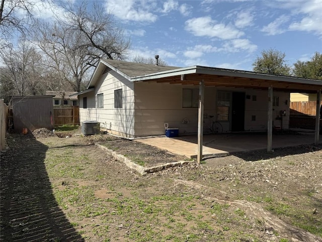 back of house with an outbuilding, a shed, a patio, and fence