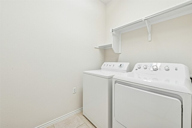 216 Farm Hill Dr, Georgetown, TX 78633 - washroom with washing machine and dryer, baseboards, and light tile patterned floors