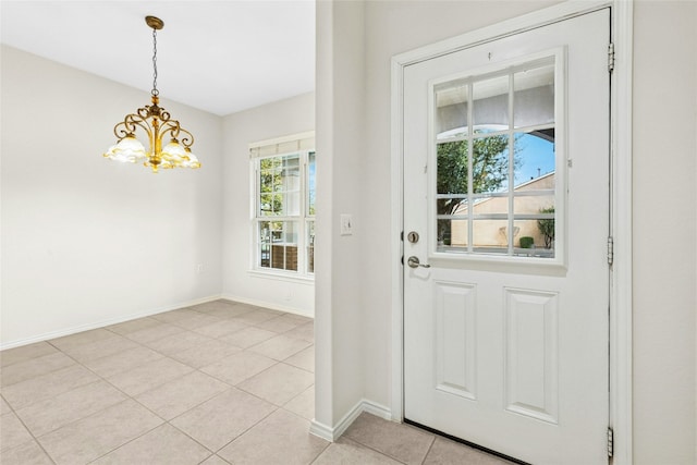 doorway to outside featuring light tile patterned flooring, baseboards, and an inviting chandelier