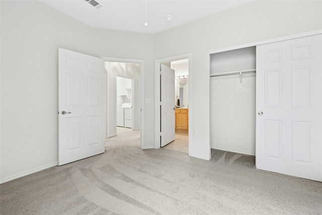 216 Farm Hill Dr, Georgetown, TX 78633 - unfurnished bedroom featuring light carpet, a closet, ensuite bathroom, washer and dryer, and baseboards