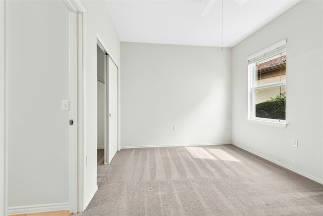 unfurnished bedroom with a ceiling fan, carpet, baseboards, and a closet