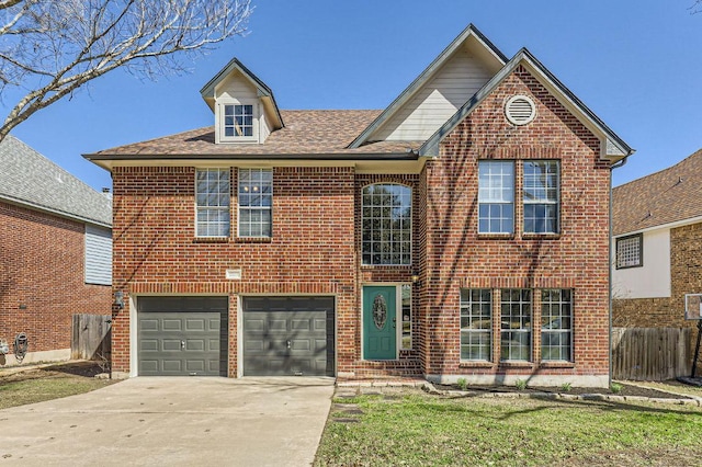 traditional-style house with a garage, fence, brick siding, and driveway