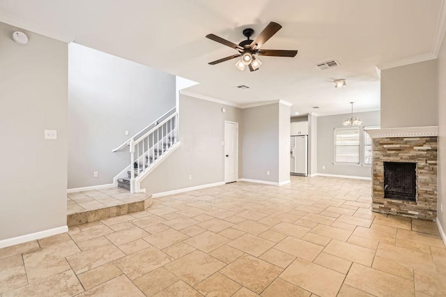 unfurnished living room with visible vents, stairs, a stone fireplace, crown molding, and ceiling fan with notable chandelier