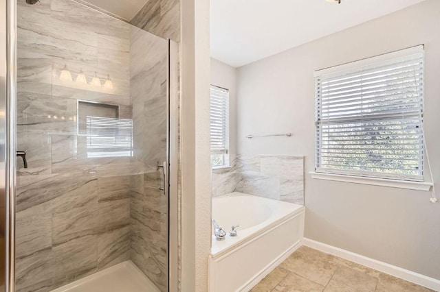 bathroom with baseboards, a bath, and a shower stall