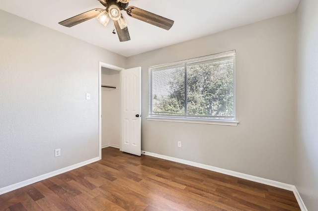 unfurnished bedroom with ceiling fan, baseboards, and wood finished floors