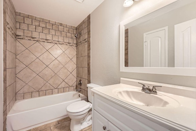 bathroom with toilet, bathing tub / shower combination, a textured wall, tile patterned floors, and vanity