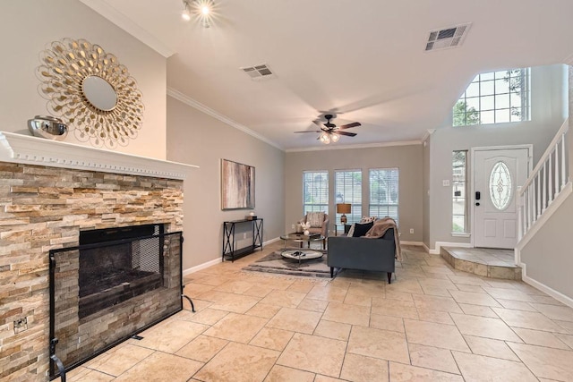 1703 Pecos Valley Cv, Round Rock, TX 78665 - living area featuring ceiling fan, ornamental molding, baseboards, stairs, and a stone fireplace
