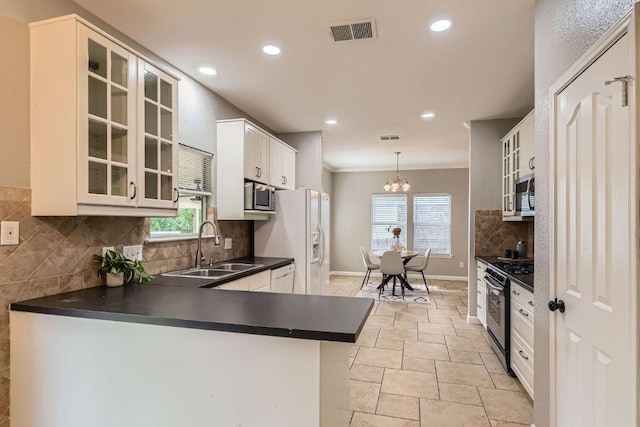 1703 Pecos Valley Cv, Round Rock, TX 78665 - kitchen featuring white appliances, a sink, dark countertops, stone tile flooring, and tasteful backsplash