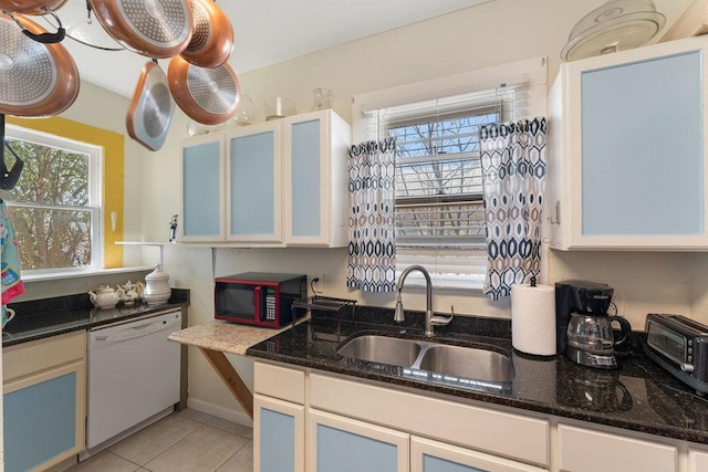 kitchen featuring a sink, dishwasher, a wealth of natural light, and light tile patterned flooring