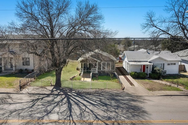 view of front of house with a fenced front yard and a front lawn