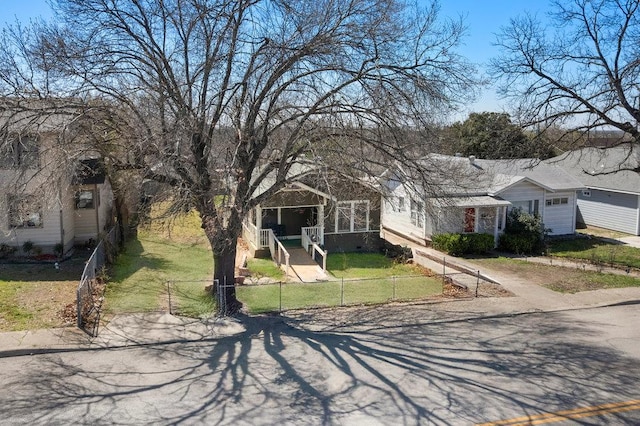 view of front of house featuring a front yard, a garage, and a fenced front yard