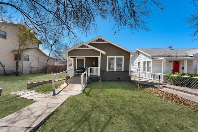 bungalow-style home featuring a front yard, fence, and crawl space