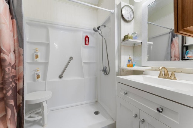 full bath featuring a stall shower and vanity