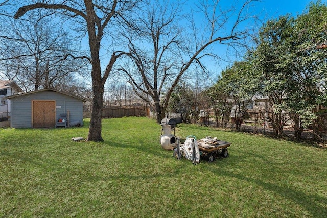 view of yard featuring an outbuilding, a shed, and a fenced backyard