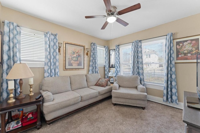 living area with baseboards, carpet floors, and a ceiling fan