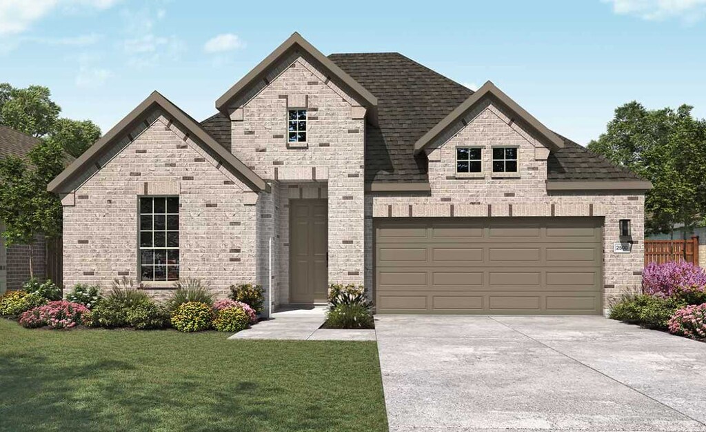 20425 Gillbrand Rd, Manor, TX 78653 - french country style house featuring driveway, a front yard, a shingled roof, a garage, and brick siding