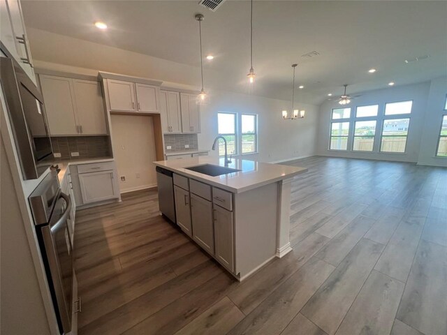 20425 Gillbrand Rd, Manor, TX 78653 - kitchen featuring recessed lighting, dark wood-style floors, appliances with stainless steel finishes, light countertops, and decorative backsplash