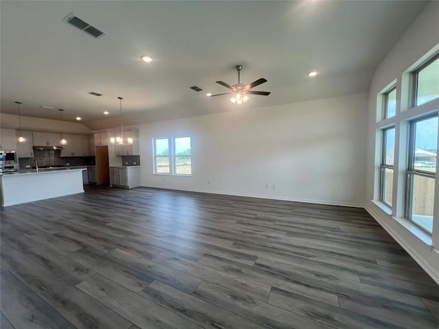 20425 Gillbrand Rd, Manor, TX 78653 - unfurnished living room with dark wood finished floors, recessed lighting, and ceiling fan