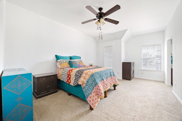 bedroom featuring baseboards, light carpet, lofted ceiling, and a ceiling fan