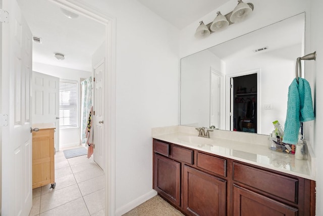 bathroom with tile patterned flooring, visible vents, vanity, and baseboards