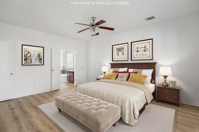 bedroom featuring visible vents, light wood finished floors, and connected bathroom