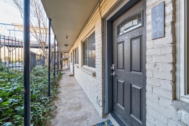 doorway to property featuring brick siding