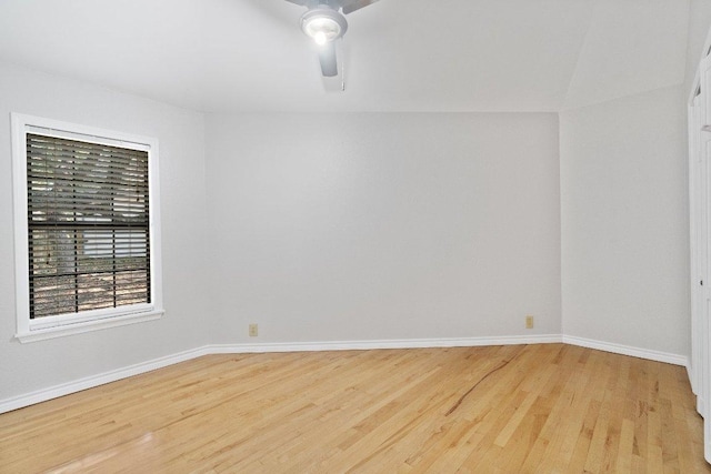 empty room featuring wood finished floors, baseboards, and ceiling fan