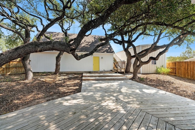 view of front of home with a deck and fence