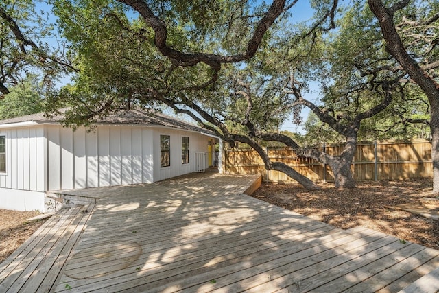 wooden terrace featuring fence