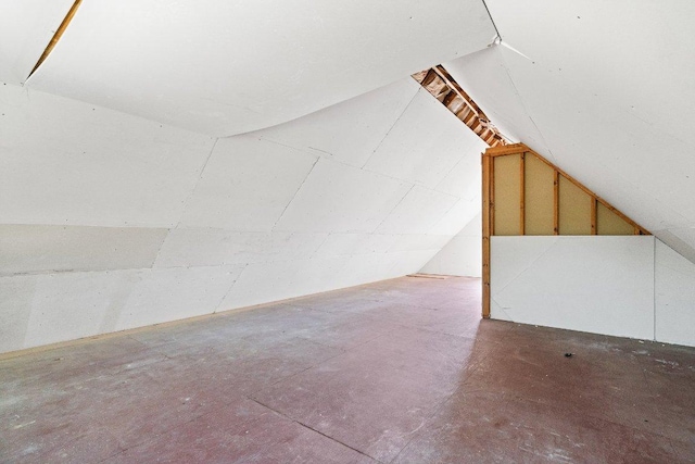 additional living space featuring vaulted ceiling