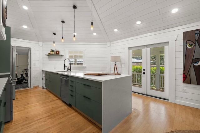 kitchen featuring green cabinetry, a sink, light countertops, vaulted ceiling, and appliances with stainless steel finishes