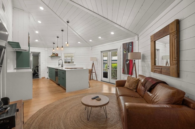 living room with french doors, lofted ceiling, wood ceiling, and light wood finished floors